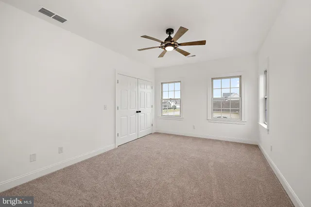 a view of a patio with couches chairs and wooden floor
