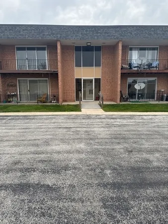 a front view of a brick house with a yard