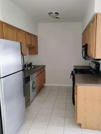 a kitchen with a refrigerator and a sink