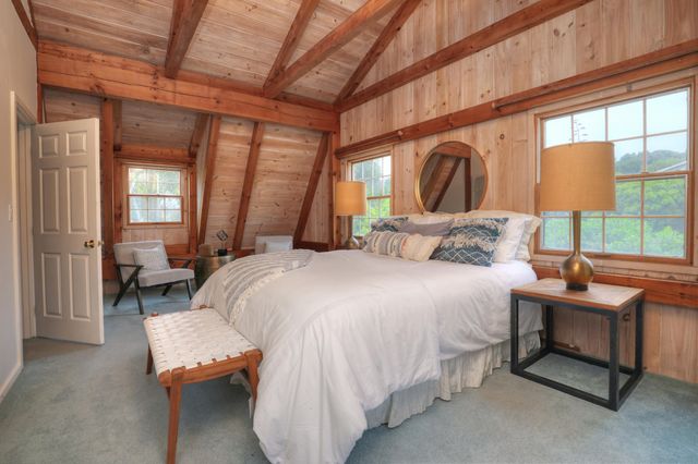 a bedroom with a bed and a large window