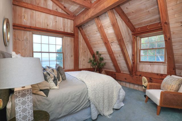 a bedroom with a bed and glass window