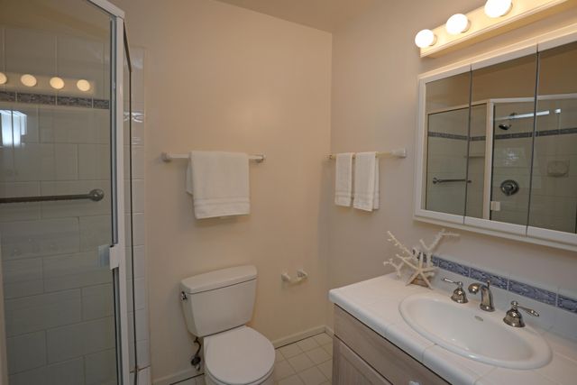 a bathroom with a sink mirror and toilet