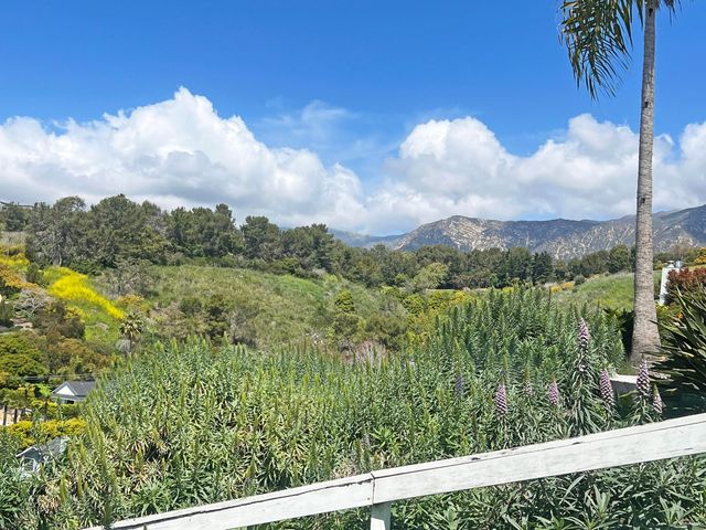 a view of a garden from a balcony