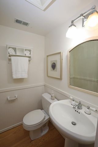 a bathroom with a sink mirror and toilet
