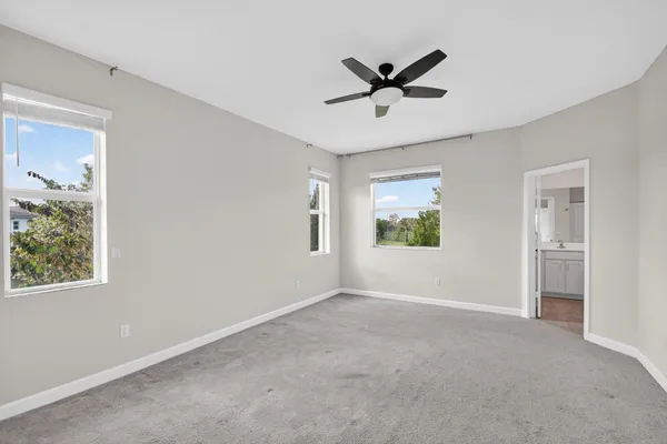 a view of a livingroom with a ceiling fan and window