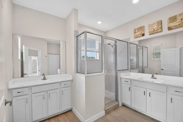 a bathroom with a double vanity sink mirror and double