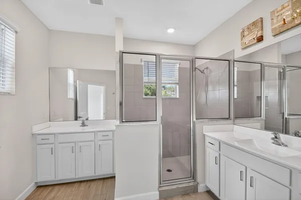 a bathroom with a double vanity sink and mirror