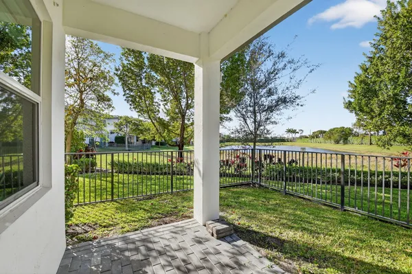 a view of a yard with a large trees in the background