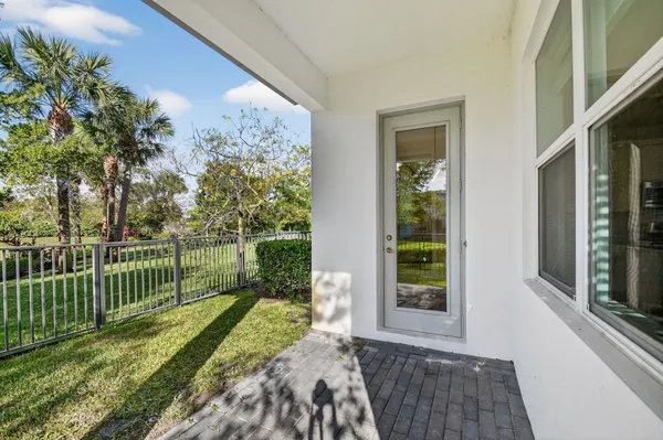 a view of a house with a small yard and wooden floor