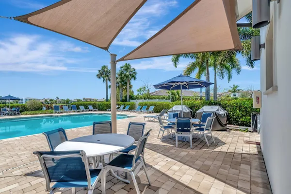 an outdoor space with furniture and umbrella