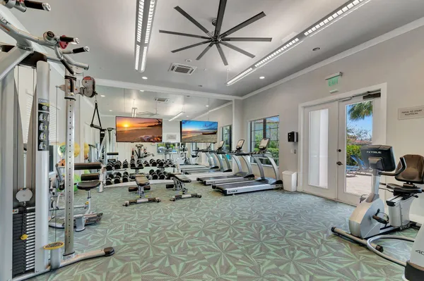 a room with lots of chairs and mirrors