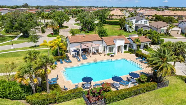 an aerial view of residential houses with outdoor space and swimming pool