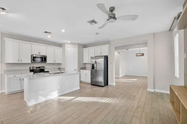 a kitchen with stainless steel appliances a refrigerator sink and stove