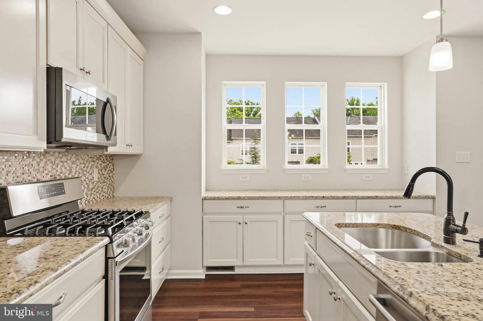 9817 Solar Course Laurel, MD 20723 - Photo 6 of 59 a kitchen with granite countertop a sink stainless steel appliances and cabinets