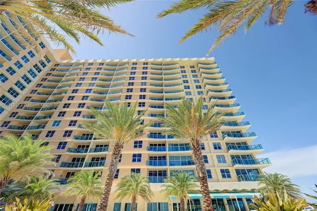 a view of multi story residential apartment building with a yard