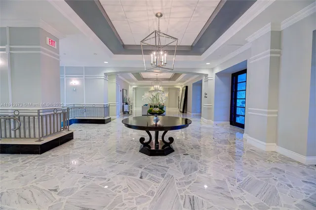 a large hall with kitchen island a stove and a sink