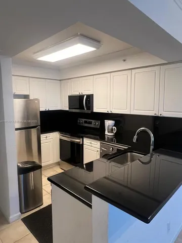 a kitchen with a table and chairs in it