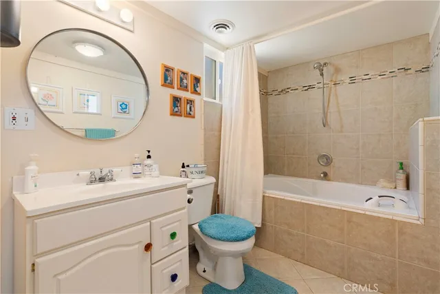 a bathroom with a toilet a sink and a mirror