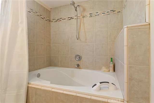 a bathroom with a tub and a shower