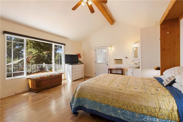 a bedroom with a bed and a large window