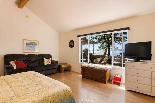 a bedroom with furniture and a flat screen tv