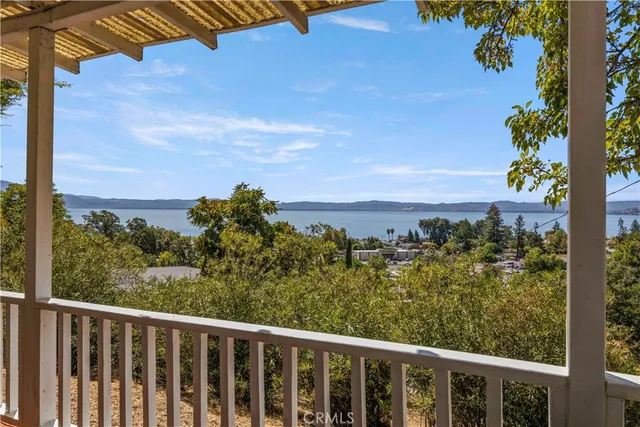 a view of a balcony with wooden floor and city view