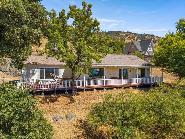 aerial view of a house with a big yard and large trees