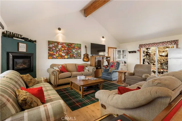 a living room with furniture fireplace and a flat screen tv