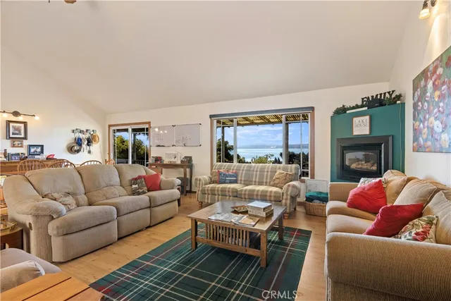 a living room with furniture fireplace and a large window
