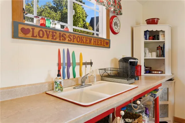 a kitchen with kitchen island and a sink