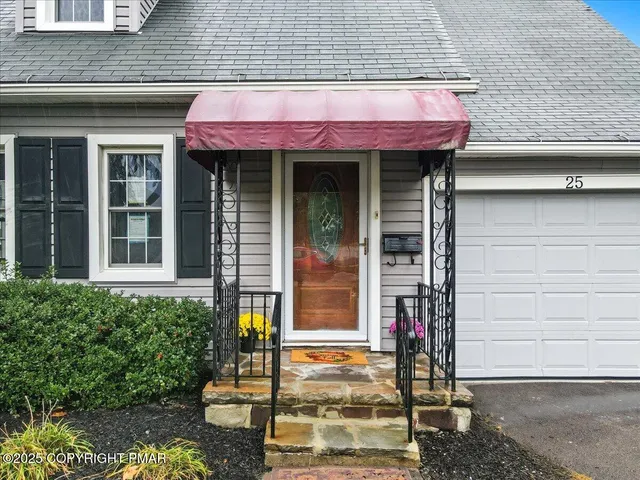 a view of empty room with wooden floor and fireplace
