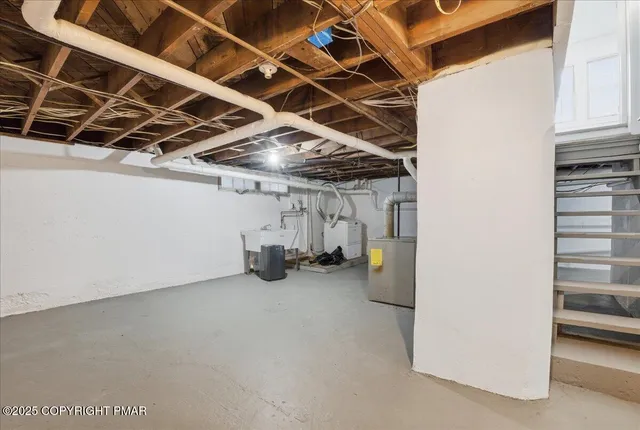a view of a house with a large window and flower plants