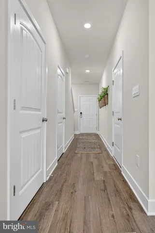 a living room with furniture kitchen view and large windows