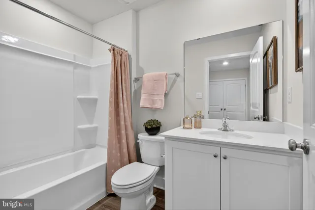 a bedroom with a bed and a night stand