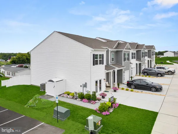 a view of a big house with a big yard and large trees