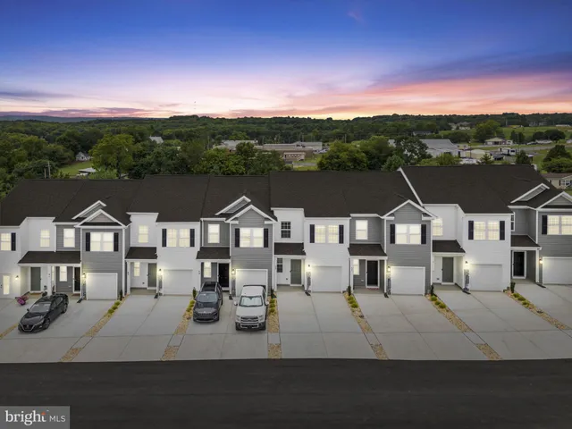 a front view of a house with a garden and yard