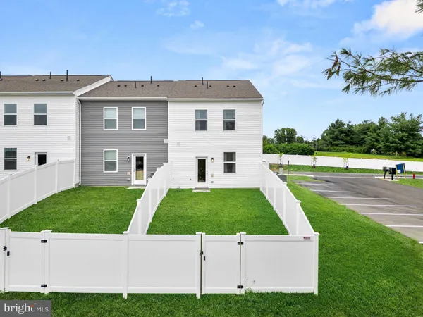 a view of a big yard with an ocean view