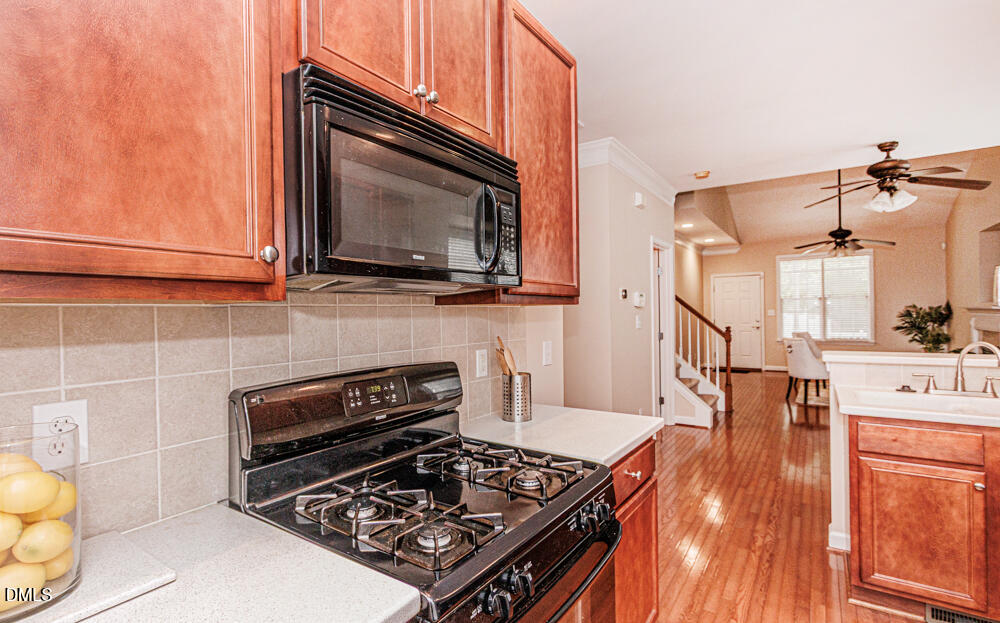 6016 Four Townes Lane Raleigh, NC 27616 - Photo 12 of 32 a kitchen with a stove and a microwave