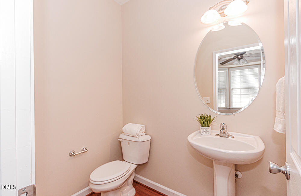 6016 Four Townes Lane Raleigh, NC 27616 - Photo 19 of 32 a bathroom with a toilet sink and mirror