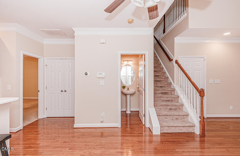 6016 Four Townes Lane Raleigh, NC 27616 - Photo 20 of 32 a view of a hallway with wooden floor and staircase