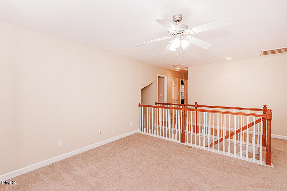 6016 Four Townes Lane Raleigh, NC 27616 - Photo 21 of 32 a view of a hallway with a ceiling fan