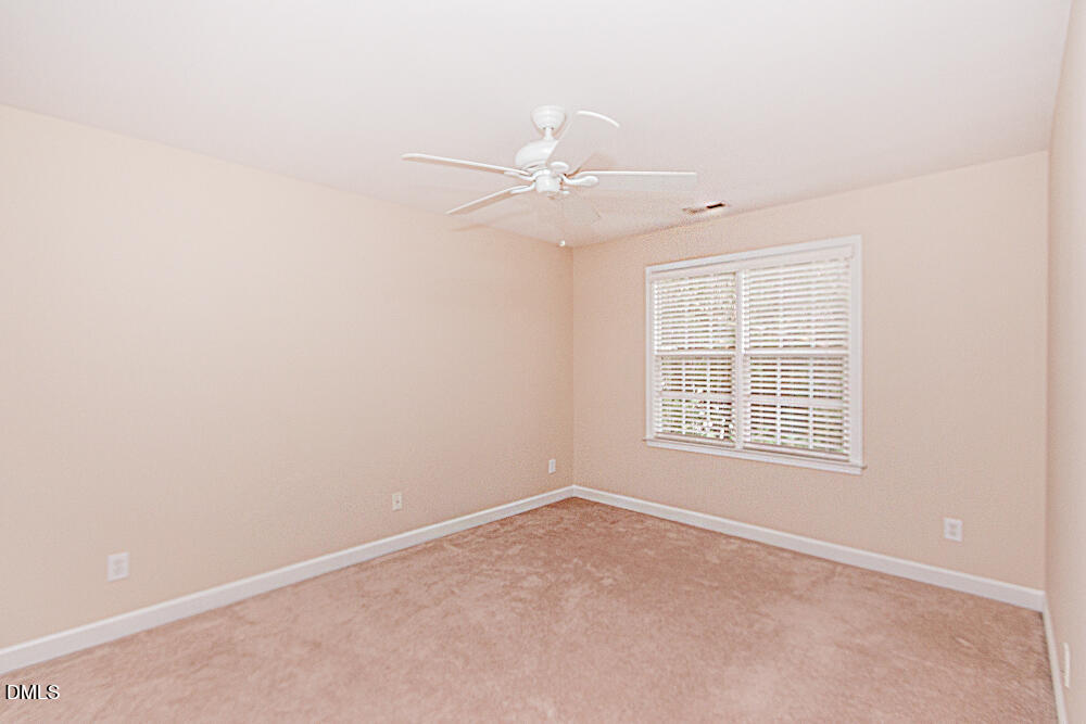 6016 Four Townes Lane Raleigh, NC 27616 - Photo 25 of 32 an empty room with a window and a fan