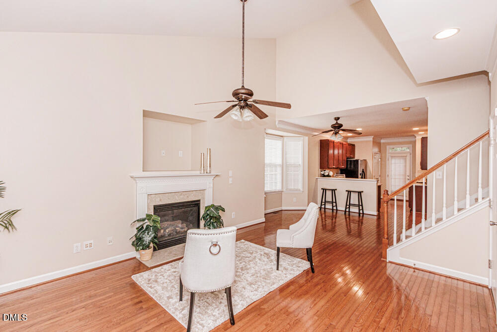 6016 Four Townes Lane Raleigh, NC 27616 - Photo 5 of 32 a living room with furniture a fireplace and a potted plant