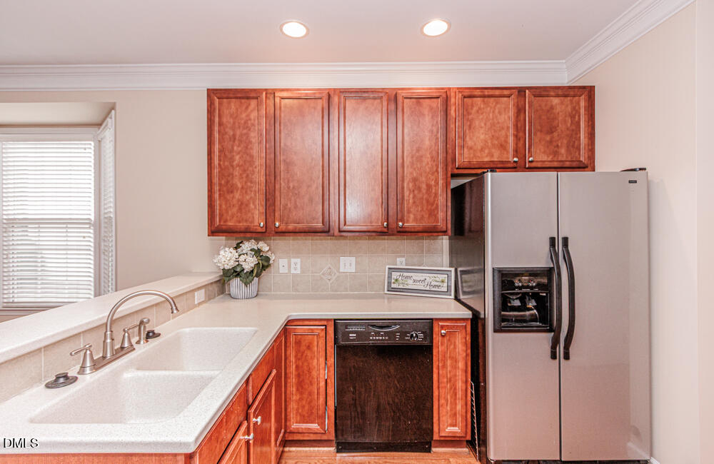 6016 Four Townes Lane Raleigh, NC 27616 - Photo 10 of 32 a kitchen with stainless steel appliances granite countertop a refrigerator a sink and dishwasher
