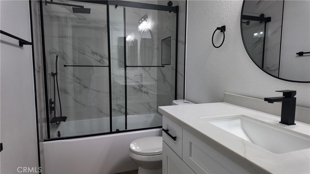 21484 Dickinson Road Moreno Valley, CA 92557 - Photo 9 of 10 a bathroom with a sink toilet and shower