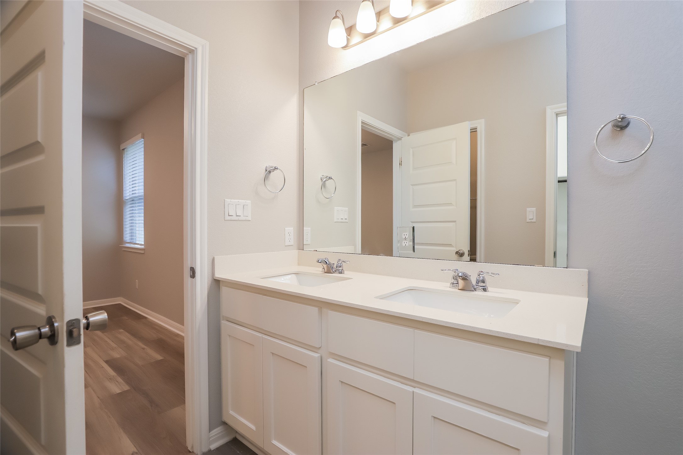 2724 Juniper Woods Road Leander, TX 78641 - Photo 10 of 21 Double vanity with sleek white countertops and ample storage offers a perfect blend of style and function.