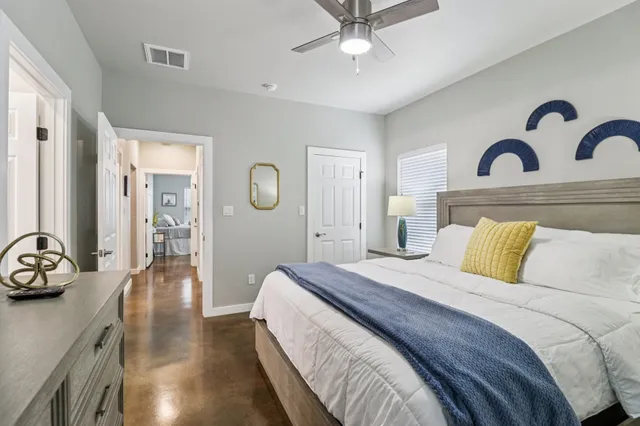 a bathroom with a granite countertop toilet a sink and mirror