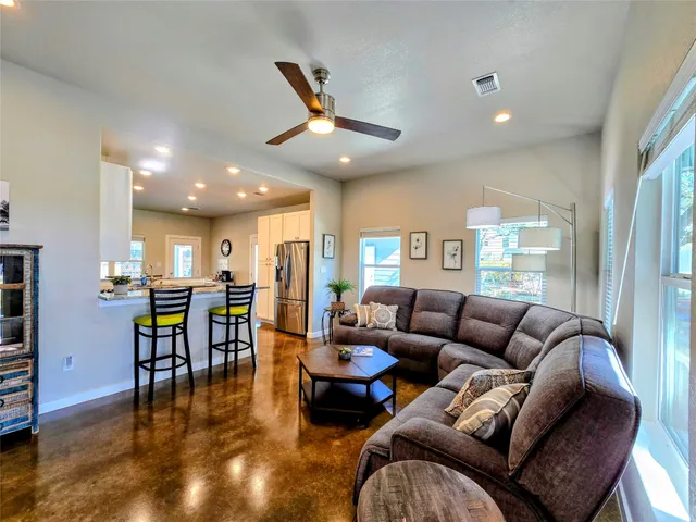 a living room with furniture and wooden floor