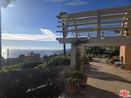 a room with furniture and large windows