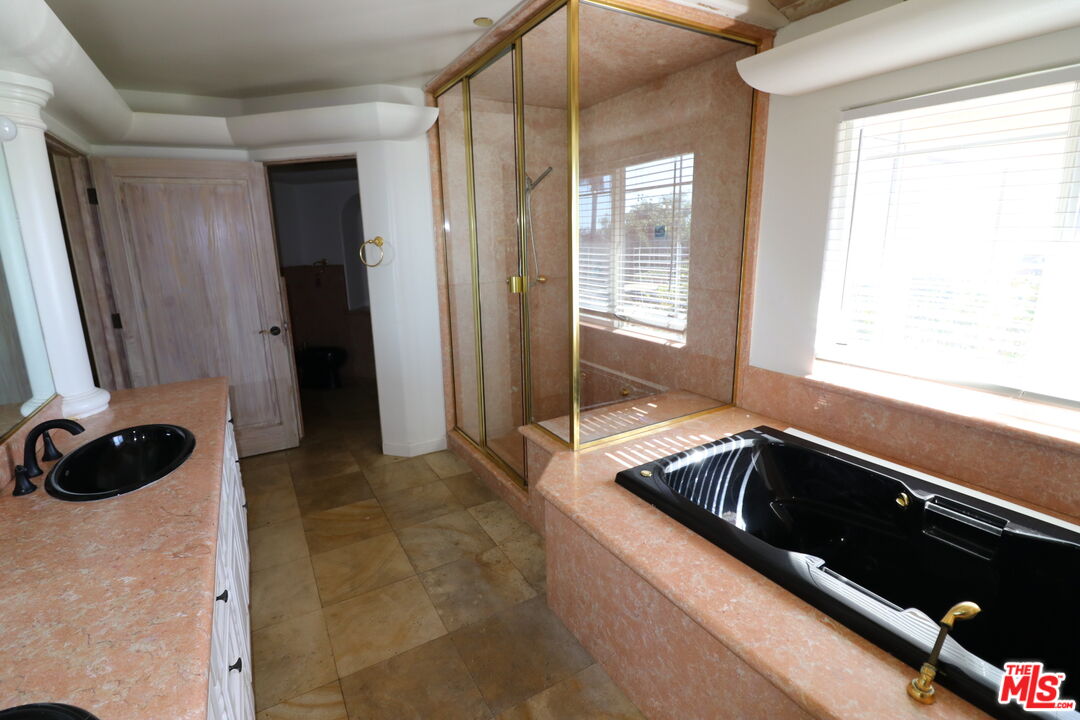 20776 Big Rock Drive Malibu, CA 90265 - Photo 44 of 67 a bath room with a sink a bath tub and a shower